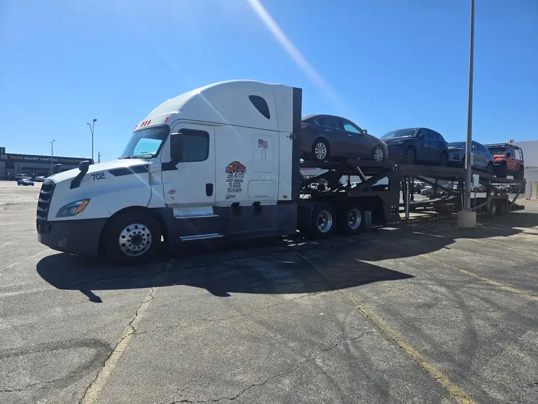 CA Auto Express open carrier truck with vehicles in sunny lot
